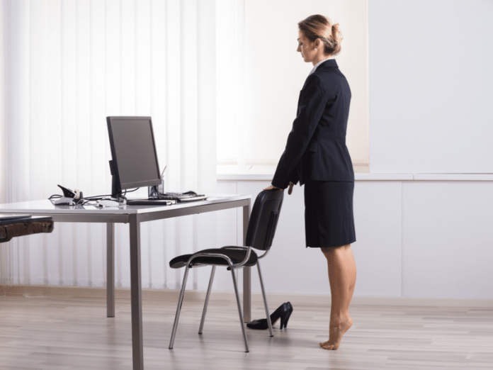 business woman doing a movement snack at her desk