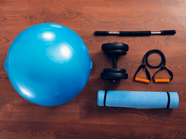 home gym essential equipment - yoga mat, foam roller, resistance bands, stability ball