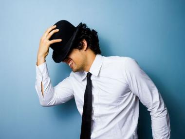 A cute man tips his hat