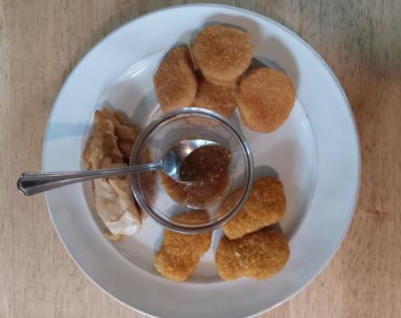 several brands of plant based chicken on a plate