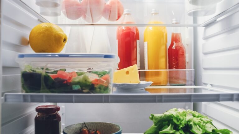 Inside a fridge with juices and vegetables
