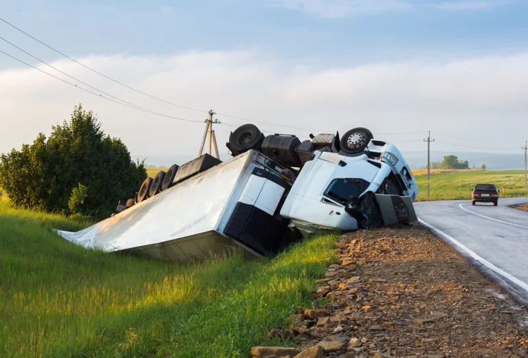 White semi truck rolled over in the grass