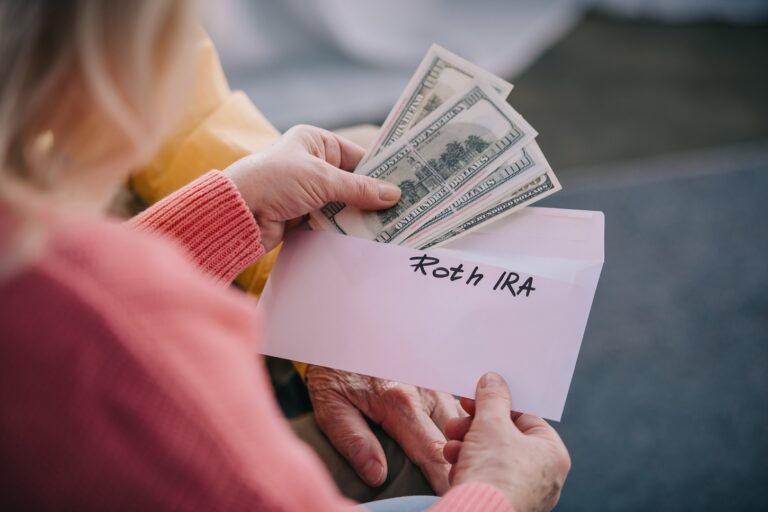 Woman putting dollar bills in an envelope.