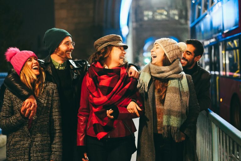 Group of young people in flannel and beanies, smiling