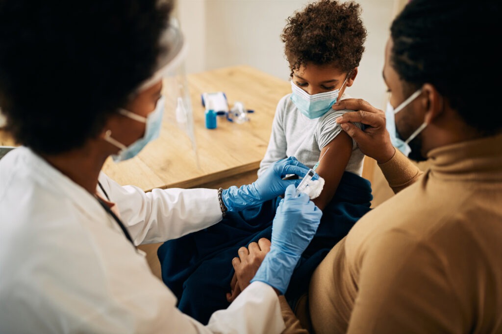 Close up of doctor giving immunization to small child