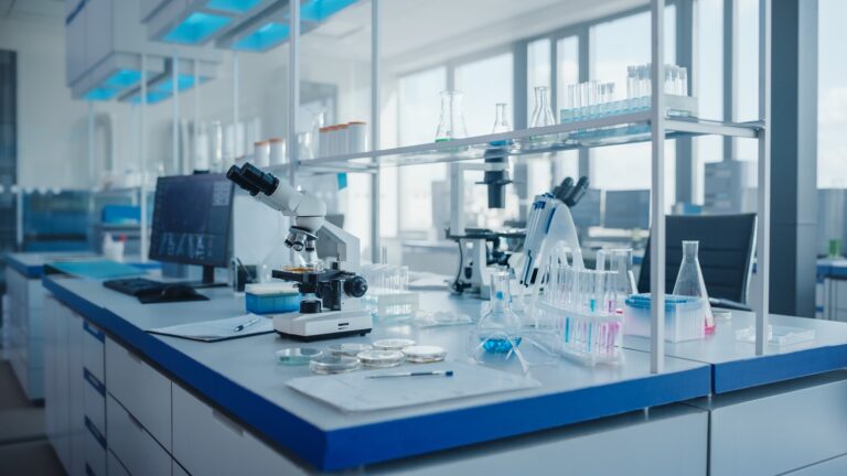 Modern medical laboratory with computer and glass beakers on counter